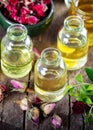 Dried herbs with essential oils for aromatherapy treatment. Bottle of rose essential oil with dried rose petals Royalty Free Stock Photo
