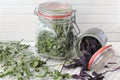 Dried Kitchen Herbs Of Basil And Mint In Glass Jars