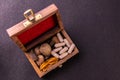 Dried herbs, spices and herbal capsules in a wooden box on black background with copy space. Herbal medicine system concept Royalty Free Stock Photo