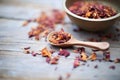 dried hibiscus flowers and loose tea by wooden scoop Royalty Free Stock Photo