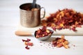 dried hibiscus flowers and loose tea by wooden scoop Royalty Free Stock Photo