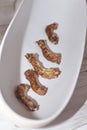 Dried homemade chicken necks in white bowl. Royalty Free Stock Photo