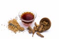 Detoxifying tea of popular Indian ayurvedic herb i.e. Indian sarsaparilla in a transparent glass cup isolated on white.