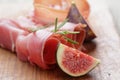 Dried jamon slices with figs on wood table Royalty Free Stock Photo