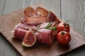 Dried jamon slices with figs on wood table Royalty Free Stock Photo