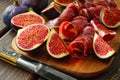 Dried jamon slices with figs on wood table Royalty Free Stock Photo