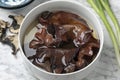 Dried jews ear mushrooms soaking in a bowl