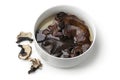 Dried jews ear mushrooms soaking in a bowl on white background