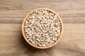 Dried Job\'s tears or adlay millet in wooden bowl on wooden background Royalty Free Stock Photo