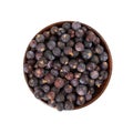 Dried juniper berries in wooden bowl Royalty Free Stock Photo
