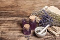 Dried lavender flowers in a in a mortar and pestle with bottle of essential lavender oil or infused water Royalty Free Stock Photo