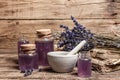 Dried lavender flowers in a in a mortar and pestle with bottle of essential lavender oil or infused water Royalty Free Stock Photo