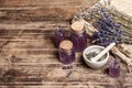 Dried lavender flowers in a in a mortar and pestle with bottle of essential lavender oil or infused water Royalty Free Stock Photo