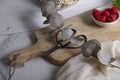 Dried leaves, wooden board, vintage scissors and a small bowl with raspberries on white table Royalty Free Stock Photo