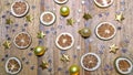 Dried lemon citrus slices, golden stars and christmas balls on wooden background. Top view. Christmas theme.