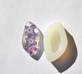 Dried lilac flower in epoxy resin tear drop. White silicone mold on white background.