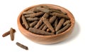 Dried long pepper, piper longum in the wooden plate, isolated on white Royalty Free Stock Photo