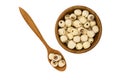 Dried lotus seeds in wooden bowl and wooden spoon on white background. Royalty Free Stock Photo