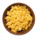 Dried macaroni cockerel scallops. Pasta in a ceramic bowl isolated on a white background