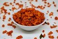 Savory and crunchy spicy macaroni in a bowl on a white background.