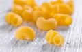 Dried macaroni on wooden background