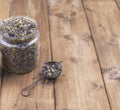 Dried mallow flowers in a jar on a wooden background. Free space for text. Copy space Royalty Free Stock Photo