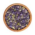 Dried purple mallow tea flowers, Malva sylvestris, in a wooden bowl