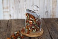 Dried marigold flowers in a glass jar for storage on a wooden background. The use of flowers Chernobrovtsy or Mary is Gold in folk Royalty Free Stock Photo