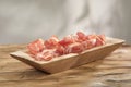 dried meat delicacy in slicing on a wooden surface. dry-cured pork on a tray. traditional snack in rustic style.