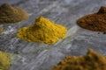 Dried mixed organic spice powders on a marble kitchen worktop background Royalty Free Stock Photo