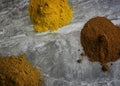 Dried mixed organic spice powders on a marble kitchen worktop background photographed from above Royalty Free Stock Photo