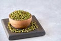 Bowl of dried mung bean on wooden board