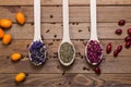 Dried myosotis Mallow flower herbal tea, Green tea and Rose flowers on spoons on wooden table Royalty Free Stock Photo