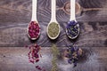 Dried myosotis Mallow flower herbal tea, Green tea and Rose flowers on spoons on wooden table Royalty Free Stock Photo