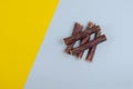 Dried natural healthy treats for dogs. Beef esophagus sticks on a yellow and blue background