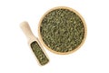 dried nettle herb or in latin Utricae folium in wooden bowl and scoop isolated on white background. medicinal healing herbs. herba