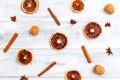 Dried orange and cinnamon, nuts on white wooden background. Flat lay Royalty Free Stock Photo