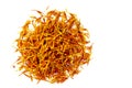 Dried orange inflorescences of safflower dye lie in the form of a circle. Latin name carthamus tinctorius. Isolated on white