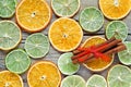 Dried orange, lemon slices and cinnamon sticks on wooden table. Royalty Free Stock Photo