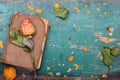 Dried orange roses and old book on wooden background, Royalty Free Stock Photo