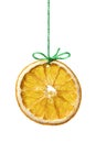 Dried orange slice hanging on a green thread on white background Royalty Free Stock Photo