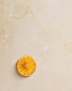 Dried orange slice on a light stone background Royalty Free Stock Photo