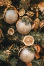 Dried orange slices and shiny silver balls on Christmas tree, pine branch. Holiday handmade deco. Merry Christmas Royalty Free Stock Photo