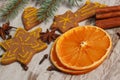 Dried orange, spices and decorated gingerbread on old wooden background, christmas decoration Royalty Free Stock Photo