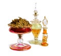 Dried Pachouli plant with vintage perfume bottle. Isolated on white background