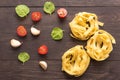 Dried pasta ingredients on the wooden background Royalty Free Stock Photo