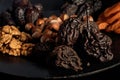 Dried pear, prunes, dried apricots on a black plate and background, selective focus. Low key. Royalty Free Stock Photo