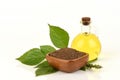 Dried Perilla seeds, green leaves and oil placed on a white background.