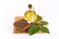 Dried Perilla seeds, green leaves and oil placed on a white background.