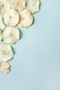 Dried pieces of Apple chips on a blue isolated background. Homemade harvesting, healthy and organic food